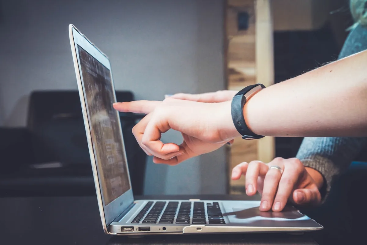 Professionals collaborating on a laptop during Shopify store development