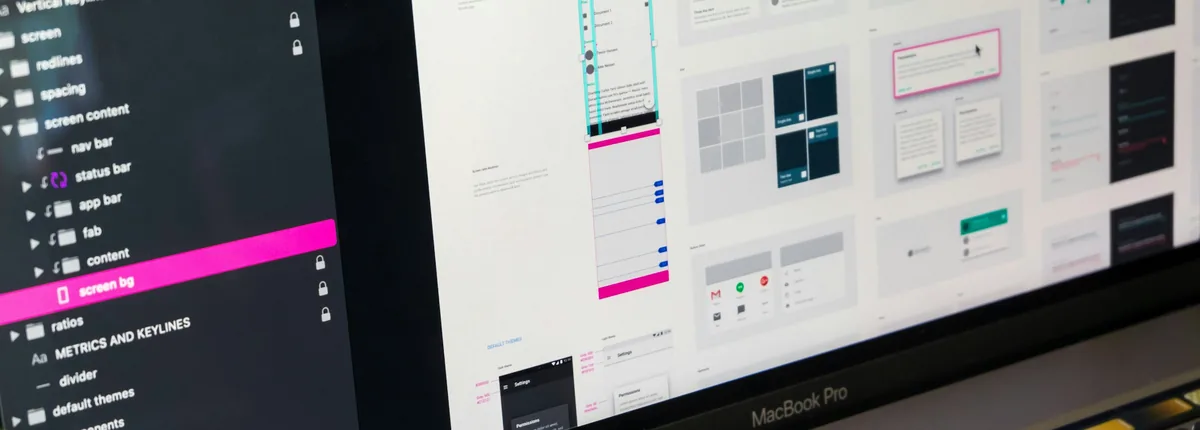 Landing page design mockups and UI wireframes displayed on a laptop screen