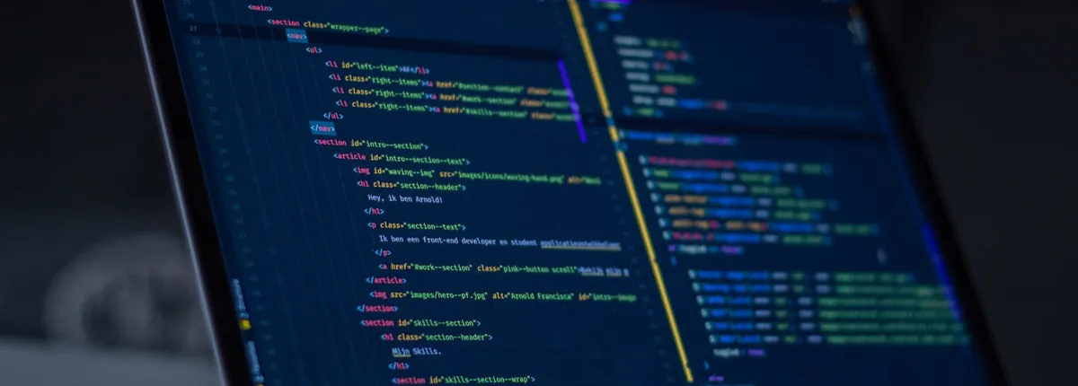 Developer laptop screen showing custom CMS website code and content structure