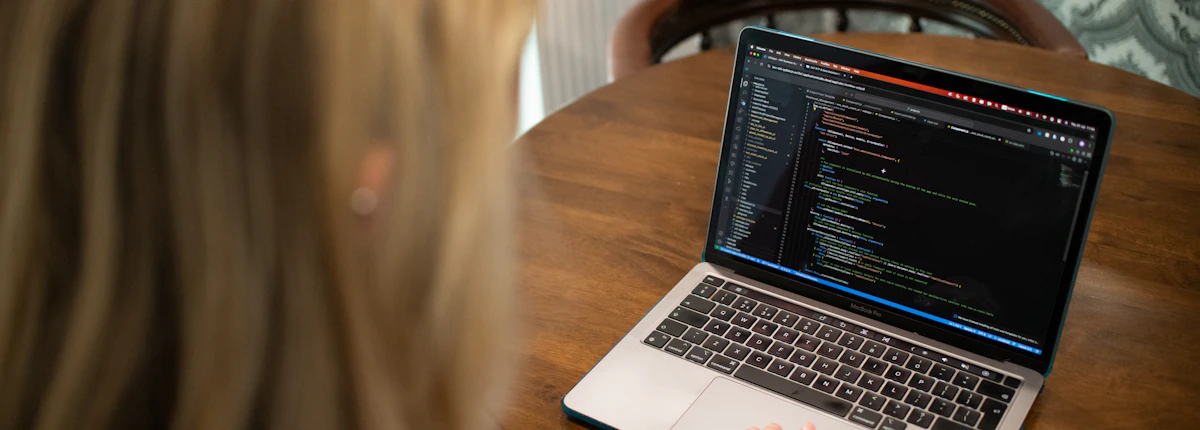 Developer updating and maintaining website code on a laptop